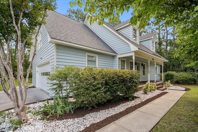 3313 Aster Ct, Wilmington, NC 28409 - view of front facade with covered porch, roof with shingles, a garage, and driveway