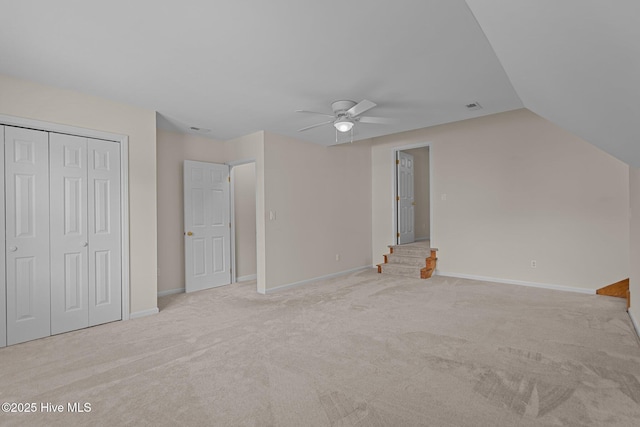 3313 Aster Ct, Wilmington, NC 28409 - unfurnished bedroom featuring carpet flooring, a closet, vaulted ceiling, and a ceiling fan