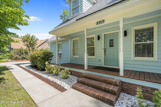 3313 Aster Ct, Wilmington, NC 28409 - doorway to property featuring covered porch, roof with shingles, and cooling unit