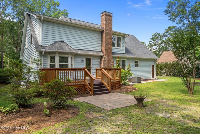 3313 Aster Ct, Wilmington, NC 28409 - rear view of house with a deck, a chimney, a yard, and roof with shingles