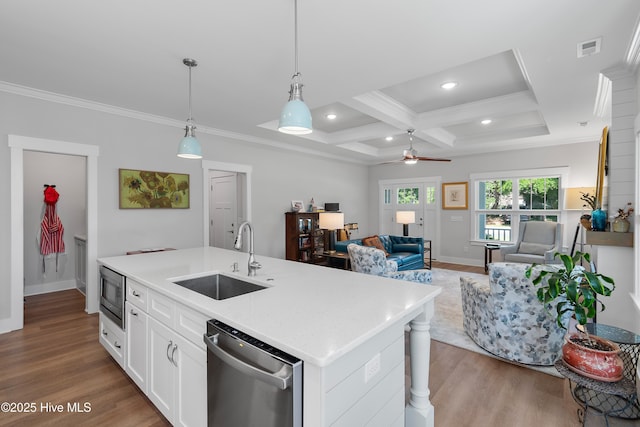 102 SW 4th St, Oak Island, NC 28465 - kitchen with appliances with stainless steel finishes, a ceiling fan, wood finished floors, coffered ceiling, and crown molding