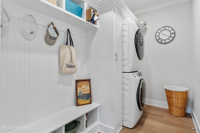 102 SW 4th St, Oak Island, NC 28465 - laundry area featuring stacked washer / dryer, light wood finished floors, and ornamental molding