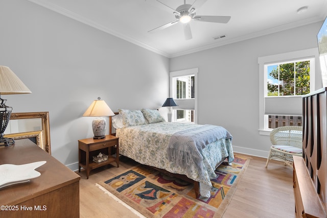 102 SW 4th St, Oak Island, NC 28465 - bedroom with light wood-style floors, ornamental molding, and ceiling fan