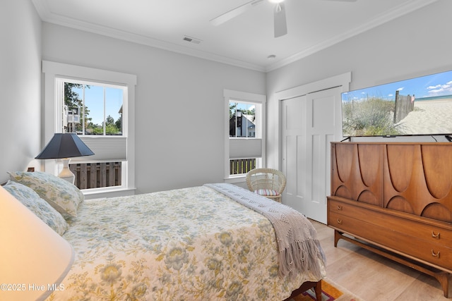 102 SW 4th St, Oak Island, NC 28465 - bedroom featuring light wood-style flooring, ornamental molding, a closet, and a ceiling fan