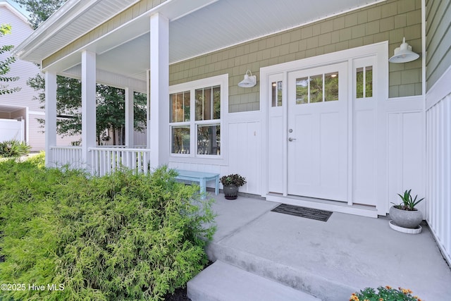 102 SW 4th St, Oak Island, NC 28465 - entrance to property with a porch and board and batten siding