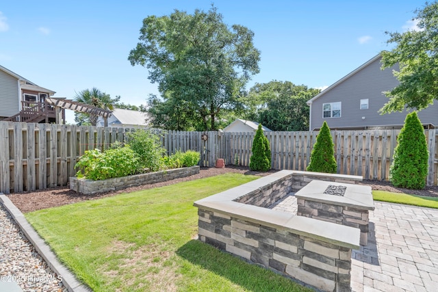 102 SW 4th St, Oak Island, NC 28465 - fenced backyard with a fire pit and a patio