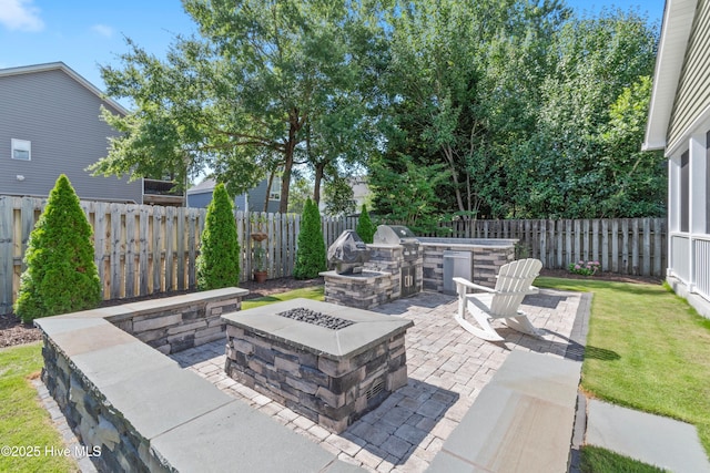 102 SW 4th St, Oak Island, NC 28465 - fenced backyard with area for grilling, a fire pit, and a patio