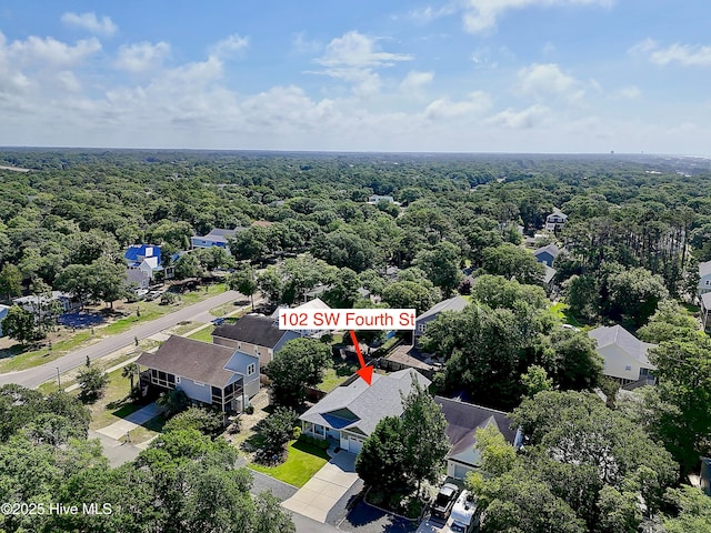 102 SW 4th St, Oak Island, NC 28465 - aerial view of residential area featuring a heavily wooded area