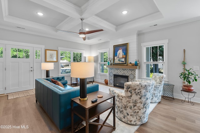 102 SW 4th St, Oak Island, NC 28465 - living area with wood finished floors, a tile fireplace, a ceiling fan, ornamental molding, and beamed ceiling