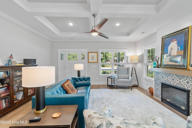 102 SW 4th St, Oak Island, NC 28465 - living room featuring coffered ceiling, wood finished floors, a tile fireplace, ceiling fan, and crown molding