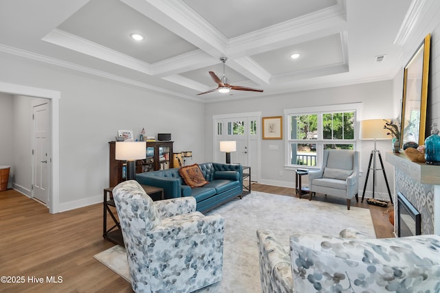 102 SW 4th St, Oak Island, NC 28465 - living room featuring wood finished floors, crown molding, coffered ceiling, beamed ceiling, and a ceiling fan