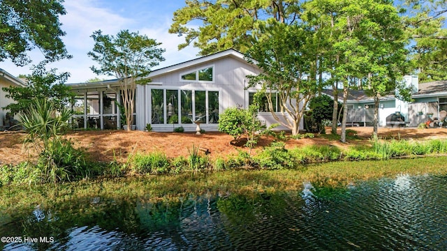 111 Mcginnis Dr, Pine Knoll Shores, NC 28512 - back of property with a sunroom and a water view