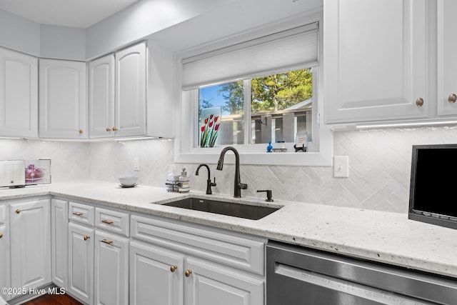 111 Mcginnis Dr, Pine Knoll Shores, NC 28512 - kitchen with dishwasher, white cabinets, decorative backsplash, and light stone counters