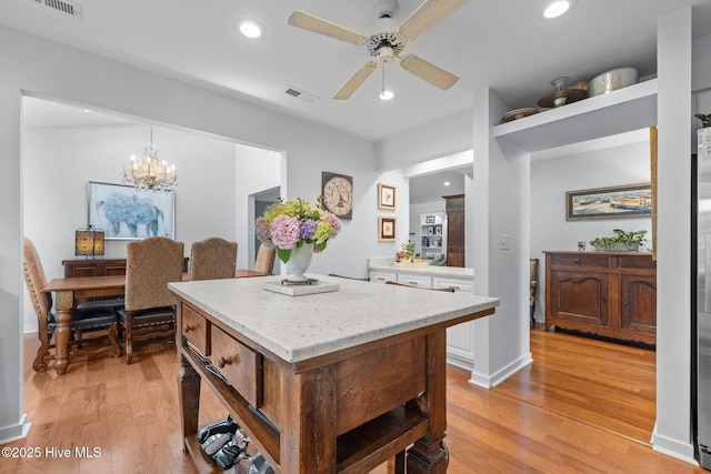 111 Mcginnis Dr, Pine Knoll Shores, NC 28512 - kitchen with white cabinets, light wood-type flooring, a ceiling fan, recessed lighting, and a center island