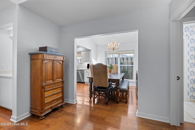 111 Mcginnis Dr, Pine Knoll Shores, NC 28512 - dining area featuring wood finished floors and a chandelier