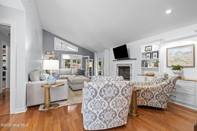 111 Mcginnis Dr, Pine Knoll Shores, NC 28512 - living area featuring vaulted ceiling, dark wood-type flooring, a fireplace, and recessed lighting