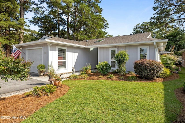 111 Mcginnis Dr, Pine Knoll Shores, NC 28512 - single story home featuring a front yard, an attached garage, and a shingled roof