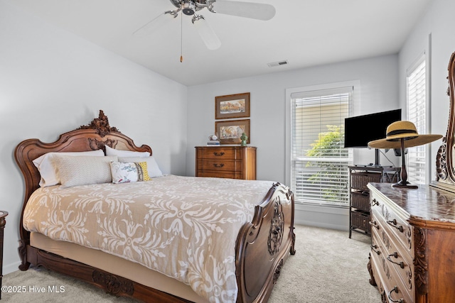 111 Mcginnis Dr, Pine Knoll Shores, NC 28512 - bedroom featuring light colored carpet, multiple windows, and a ceiling fan