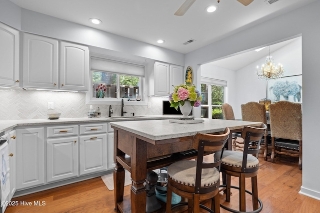 111 Mcginnis Dr, Pine Knoll Shores, NC 28512 - kitchen with tasteful backsplash, plenty of natural light, light wood-type flooring, and recessed lighting