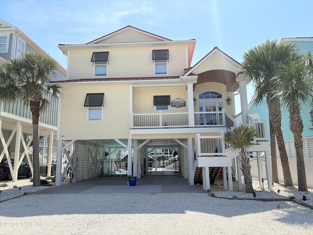 23 Leland St, Ocean Isle Beach, NC 28469 - coastal home featuring a carport, driveway, and stairway