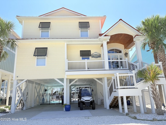 23 Leland St, Ocean Isle Beach, NC 28469 - beach home with a carport, stairs, driveway, and covered porch