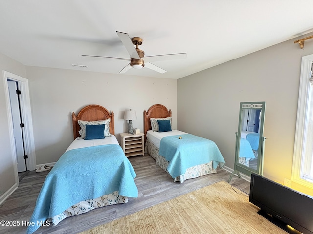 23 Leland St, Ocean Isle Beach, NC 28469 - bedroom with wood finished floors, a ceiling fan, and multiple windows