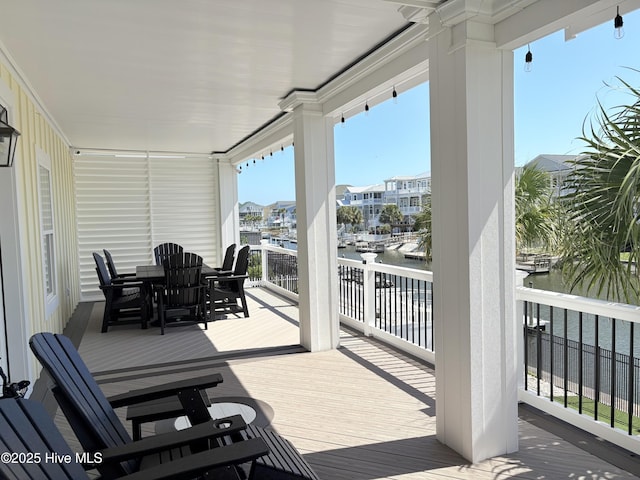 23 Leland St, Ocean Isle Beach, NC 28469 - wooden terrace featuring outdoor dining area and a water view