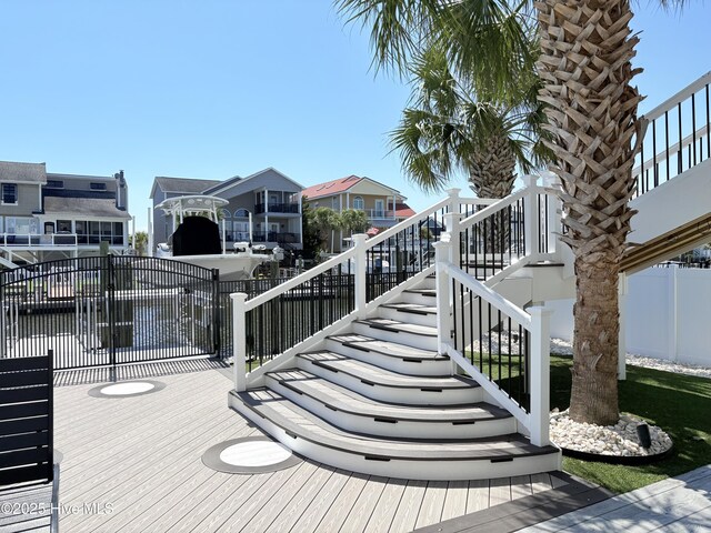 23 Leland St, Ocean Isle Beach, NC 28469 - wooden terrace featuring stairway and a residential view