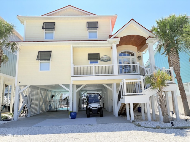 23 Leland St, Ocean Isle Beach, NC 28469 - raised beach house featuring a carport, driveway, and stairs