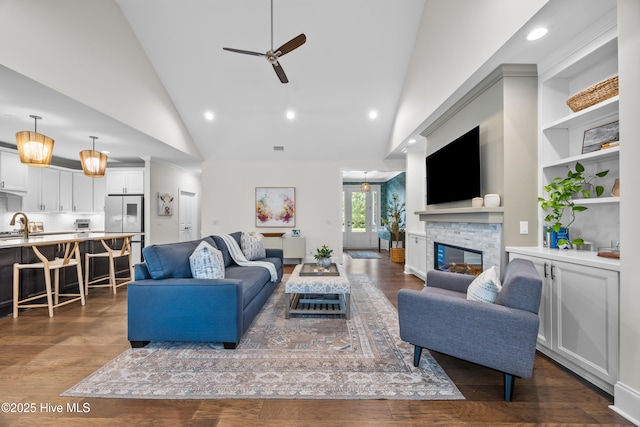 3478 Belle Meade Way NE, Leland, NC 28451 - living room featuring ceiling fan, high vaulted ceiling, a fireplace, dark wood-style flooring, and recessed lighting
