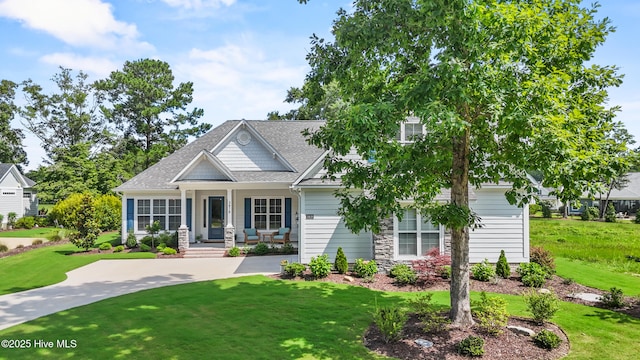 3478 Belle Meade Way NE, Leland, NC 28451 - view of front of property with covered porch, a front yard, a shingled roof, and stone siding