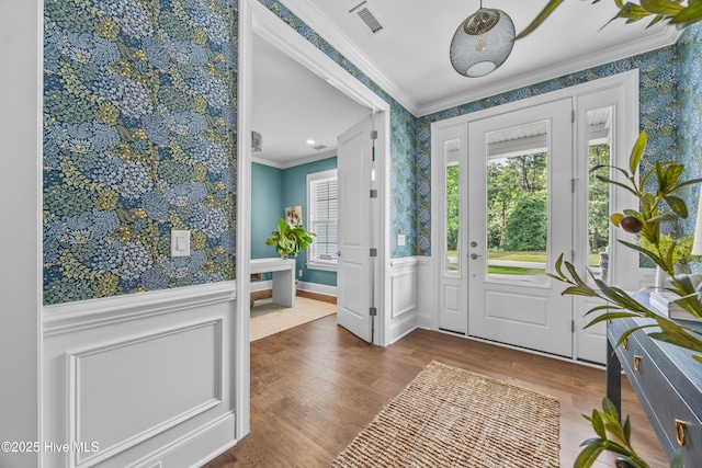 3478 Belle Meade Way NE, Leland, NC 28451 - entrance foyer featuring wallpapered walls, ornamental molding, a wainscoted wall, and dark wood-type flooring