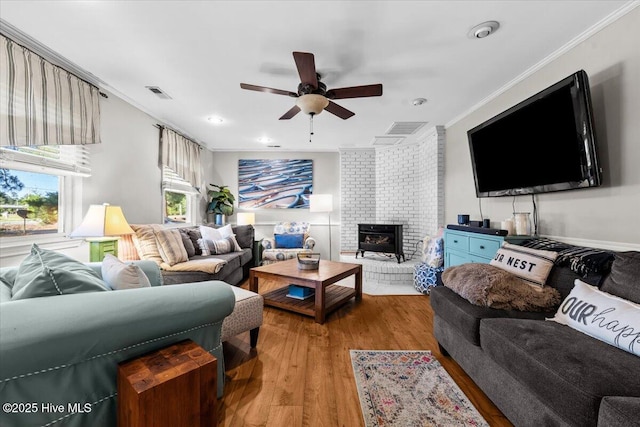 1484 Rays Bridge Rd, Whispering Pines, NC 28327 - living area featuring crown molding, ceiling fan, light wood-style floors, and a brick fireplace