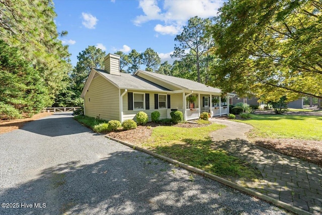 1484 Rays Bridge Rd, Whispering Pines, NC 28327 - single story home featuring a porch, a chimney, and a front yard
