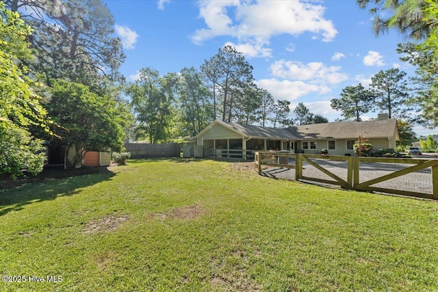 1484 Rays Bridge Rd, Whispering Pines, NC 28327 - fenced backyard featuring a sunroom and an outdoor structure