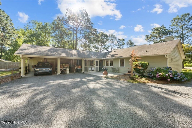 1484 Rays Bridge Rd, Whispering Pines, NC 28327 - view of front of home featuring a carport, gravel driveway, and a chimney