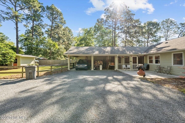 1484 Rays Bridge Rd, Whispering Pines, NC 28327 - view of front of house with asphalt driveway and a carport