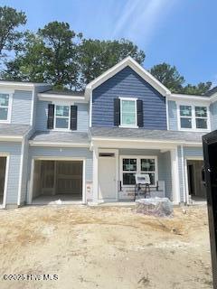 806 Palm Frond Way Unit 44, Calabash, NC 28467 - view of front of house with a garage, driveway, and a porch