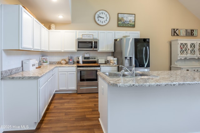 337 Brewington Rd, Clinton, NC 28328 - kitchen with appliances with stainless steel finishes, dark wood-style floors, backsplash, white cabinetry, and lofted ceiling