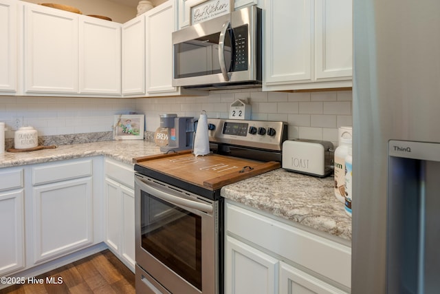 337 Brewington Rd, Clinton, NC 28328 - kitchen with stainless steel appliances, backsplash, white cabinets, dark wood-style floors, and light stone counters