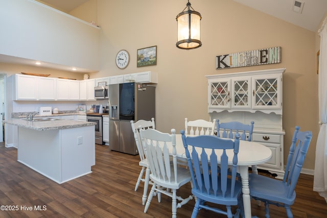337 Brewington Rd, Clinton, NC 28328 - dining room featuring dark wood-type flooring and high vaulted ceiling