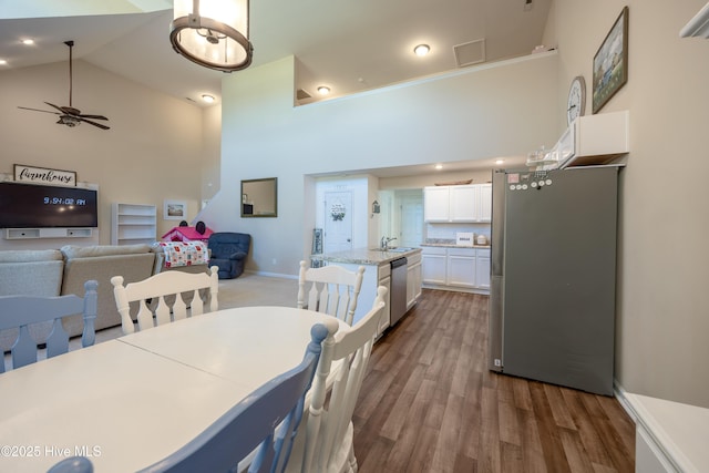 337 Brewington Rd, Clinton, NC 28328 - dining area with high vaulted ceiling, ceiling fan, and dark wood-type flooring
