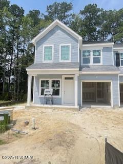 808 Palm Frond Way, Calabash, NC 28467 - view of front of house featuring dirt driveway, a garage, and a porch