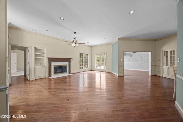 7006 Club House Dr, New Bern, NC 28562 - unfurnished living room featuring ceiling fan, ornamental molding, hardwood / wood-style flooring, a fireplace, and recessed lighting