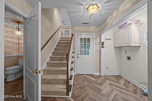 7006 Club House Dr, New Bern, NC 28562 - laundry room with washer hookup, dark wood finished floors, and cabinet space
