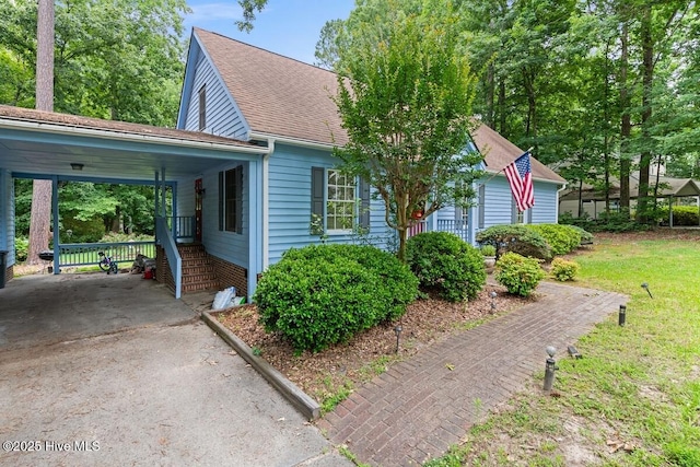 5025 Netherwood Rd, Rocky Mount, NC 27803 - view of front facade featuring asphalt driveway, roof with shingles, and a carport