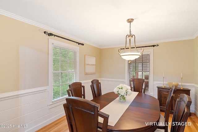 5025 Netherwood Rd, Rocky Mount, NC 27803 - dining space with light wood-style flooring, plenty of natural light, wainscoting, and crown molding