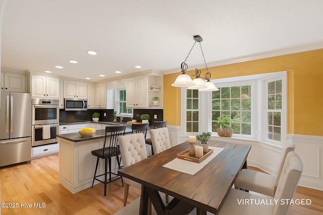 5025 Netherwood Rd, Rocky Mount, NC 27803 - dining area featuring light wood finished floors, a wainscoted wall, and recessed lighting