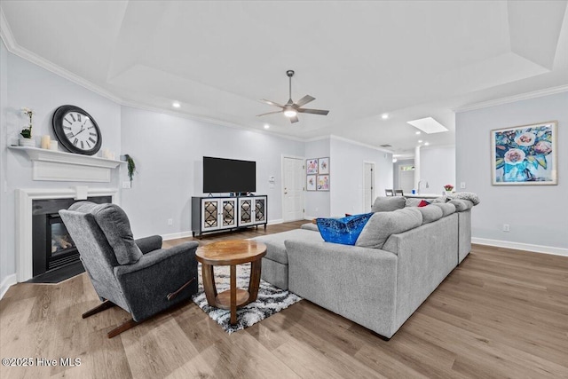 4465 Orchard Knob Ln, High Point, NC 27265 - living room featuring wood finished floors, recessed lighting, a ceiling fan, ornamental molding, and a fireplace with flush hearth