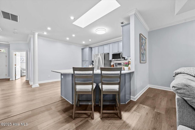 4465 Orchard Knob Ln, High Point, NC 27265 - kitchen with appliances with stainless steel finishes, crown molding, light countertops, gray cabinetry, and a peninsula